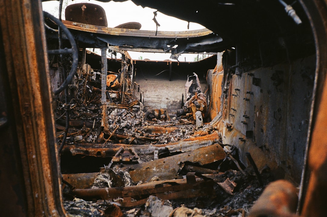 Interior of a fire-damaged vehicle showing extensive charred remains, melted metal, and debris, illustrating the aftermath of a fire incident relevant to homeowners dealing with fire damage in Phoenix.