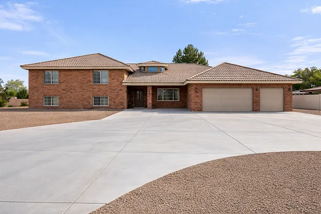 Spacious brick home with a large driveway and two-car garage, ideal for Scottsdale homeowners looking to sell quickly for cash.