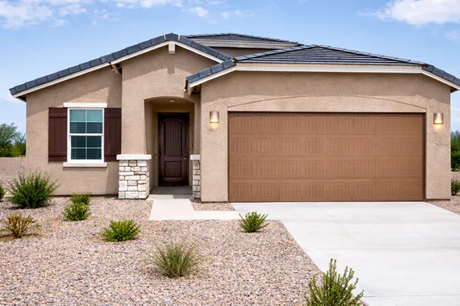 Single-story home in Scottsdale with a brown garage door, stone accents, and landscaped gravel yard, representing properties sold by Desert Cash Buyers.